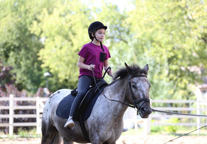 Girl riding pony