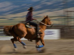 blurred picture of a western rider galloping