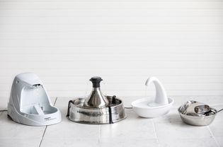 Assortment of best cat water fountains displayed on tile floo